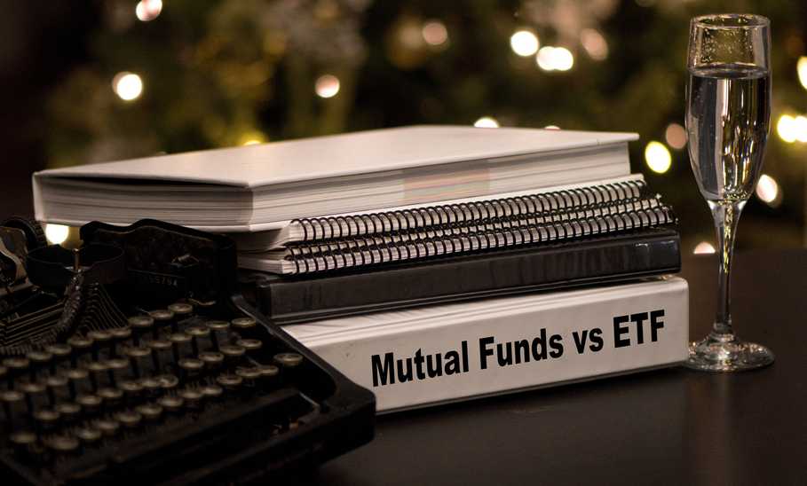 Mutual Funds vs etf written on a binder next to a typewriter and a champagne glass 