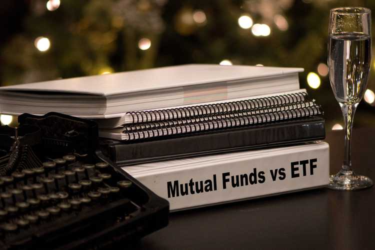 Mutual Funds vs etf written on a binder next to a typewriter and a champagne glass 